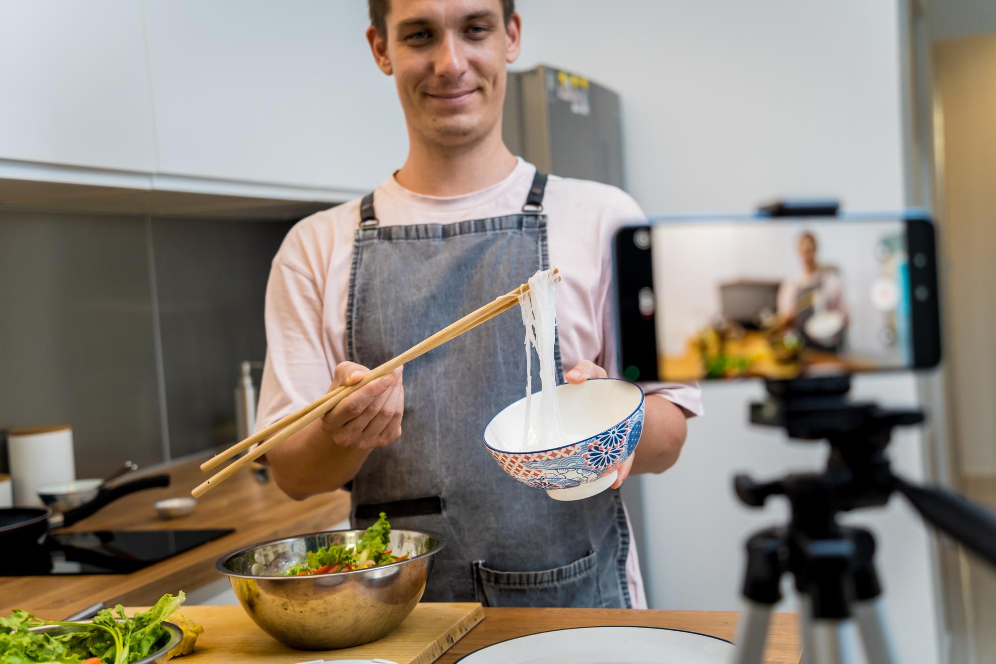 Instructor preparing a simple dish in a studio kitchen